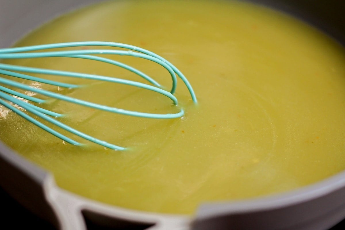 This chicken enchilada recipe is bursting with flavor and perfect for busy nights. Plus, it's freezer-friendly! Enchilada sauce in pot.