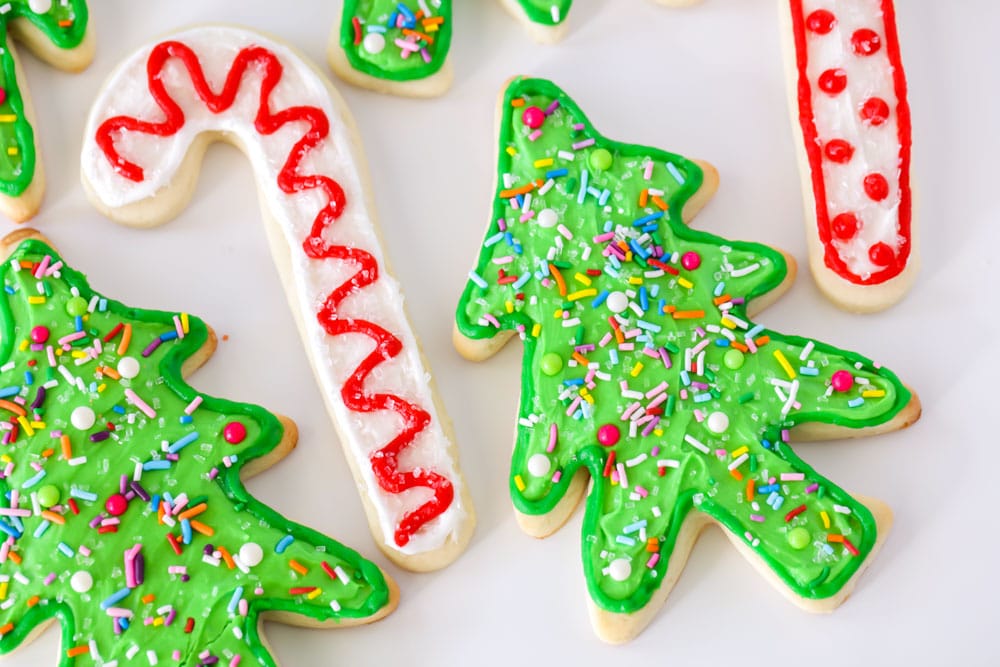 Enjoy our Favorite Christmas cookies plus dozens of others to bake and share this holiday season! Christmas sugar cookies on a white countertop.