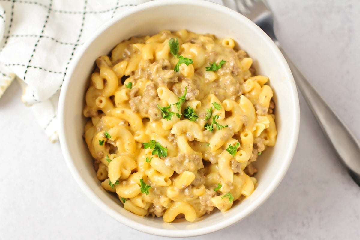 Better than the box, Homemade Hamburger Helper is a perfect one-pot meal that comes together in under 30 minutes! A bowl of homemade hamburger helper topped with fresh parsley.