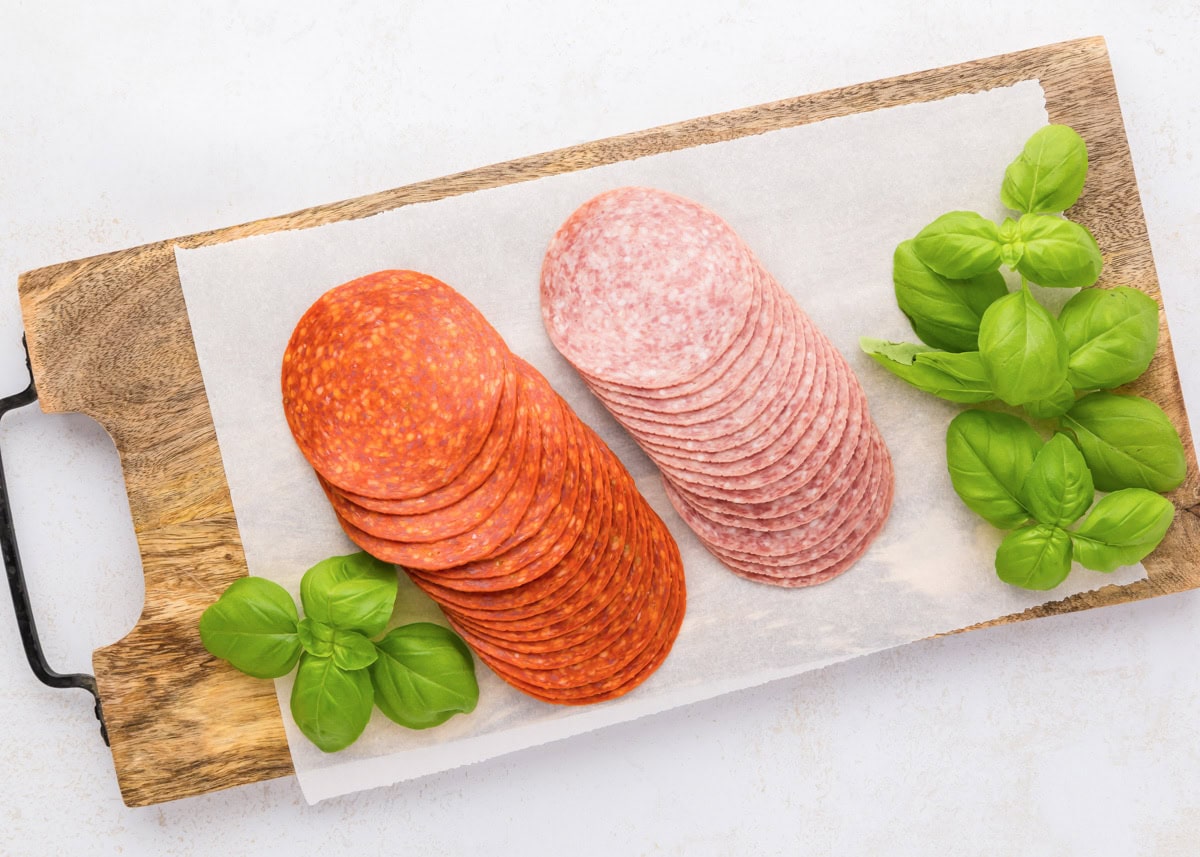 Pepperoni roses are a fun and easy way to elevate your charcuterie board, adding a beautiful and delicious touch. Pepperoni and salami on a cutting board.