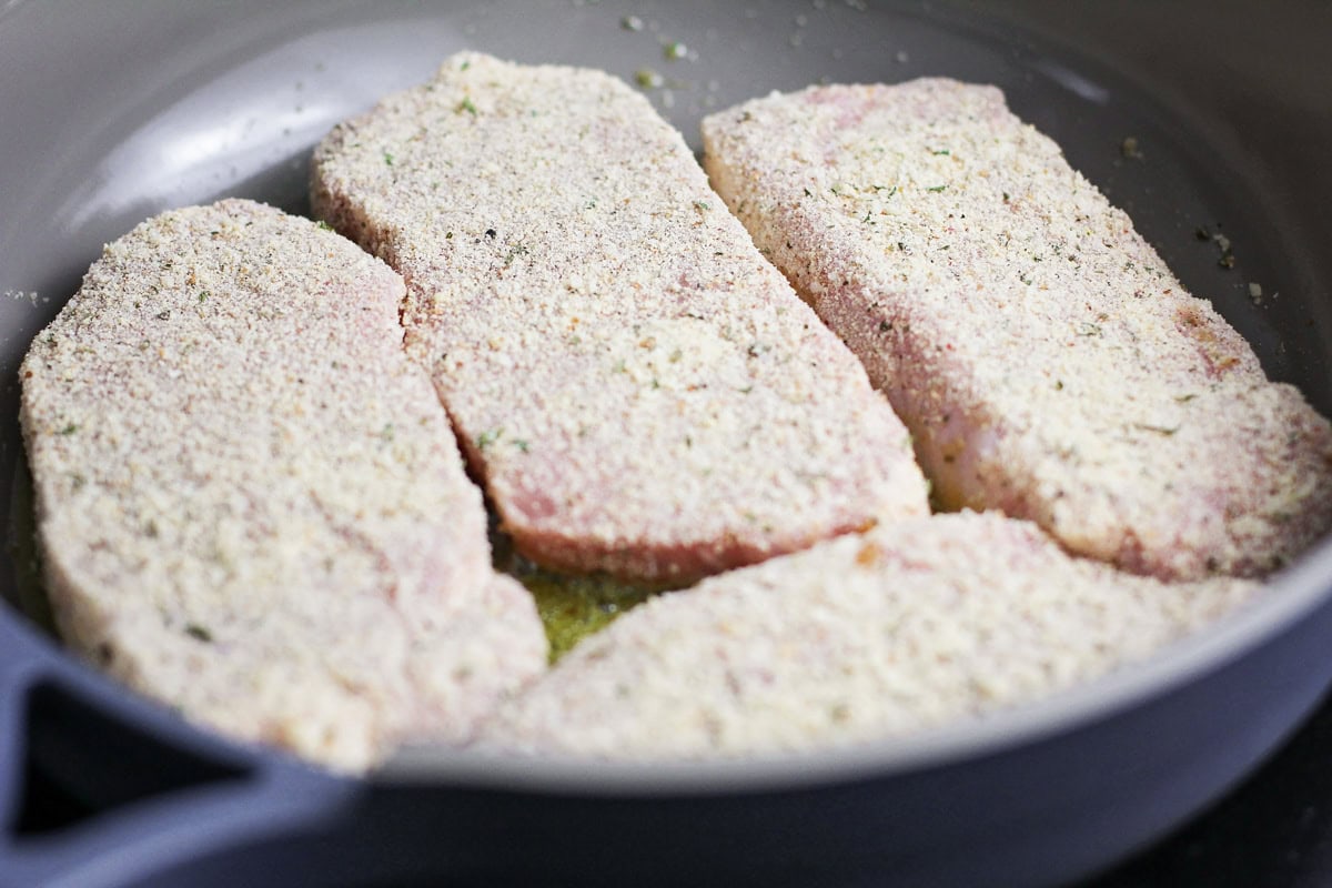Crusted with parmesan and fried up with less than 10 minutes of prep work, this is definitely the best pork chop recipe you'll ever try!! Best Pork chops being seared in skillet.
