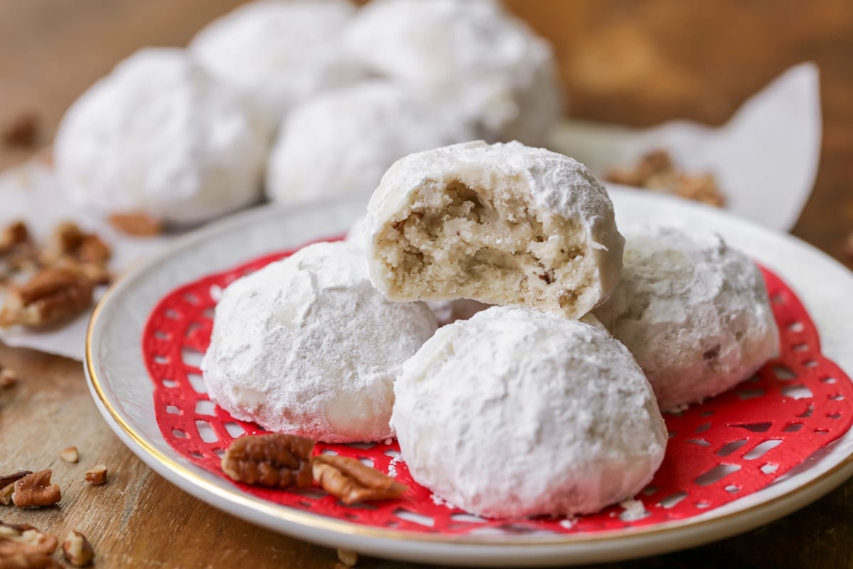 Enjoy our Favorite Christmas cookies plus dozens of others to bake and share this holiday season! Snowball Cookies on a Christmas plate